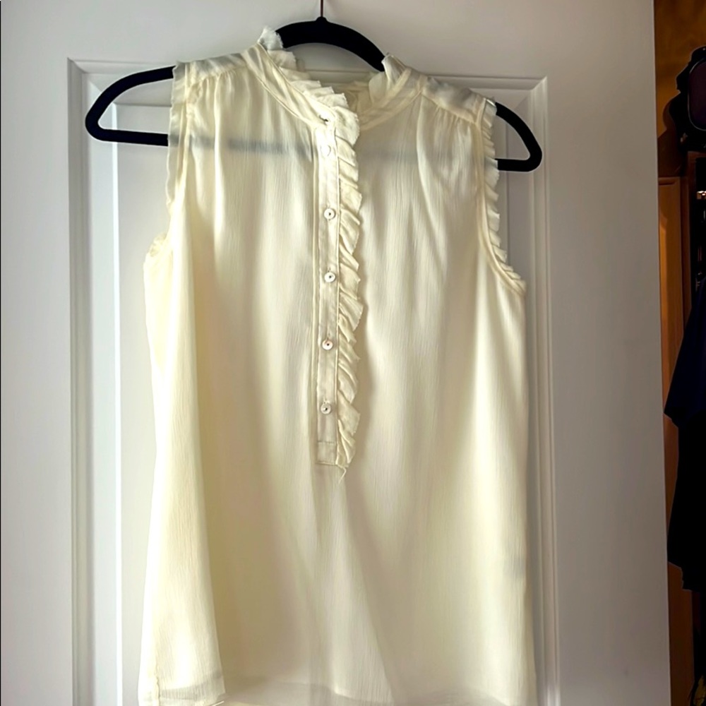 Sleeveless ruffled cream blouse